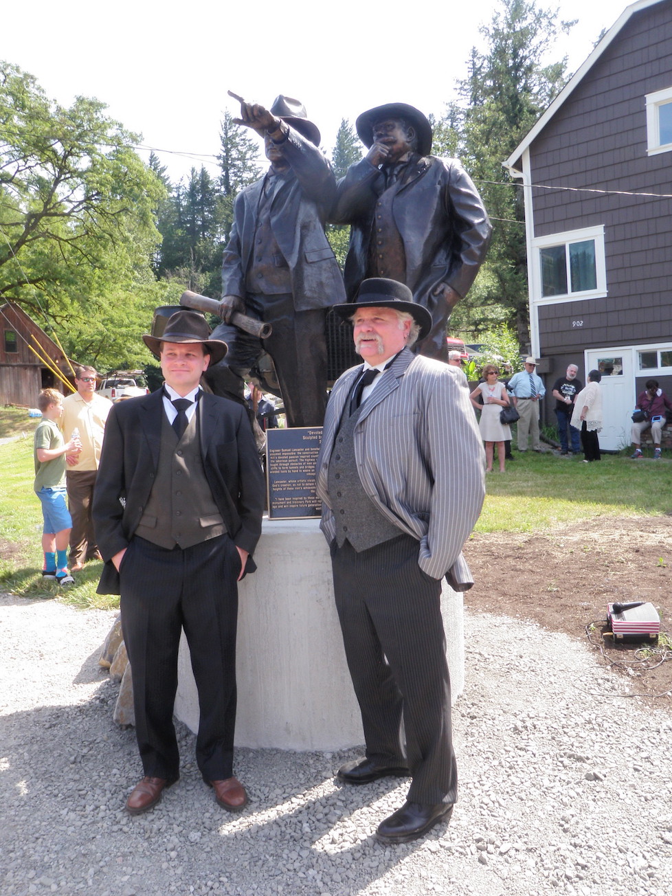 MOdels of Sam Hill and Sam Lancaster pose next to new statue