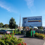 A Dutch Bros sign in a parking lot